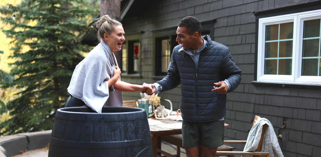 Woman and man celebrating her first ice bath in an Ice Barrel