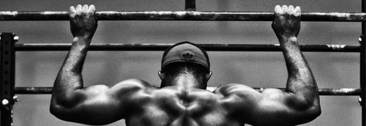 muscular man doing pull-ups