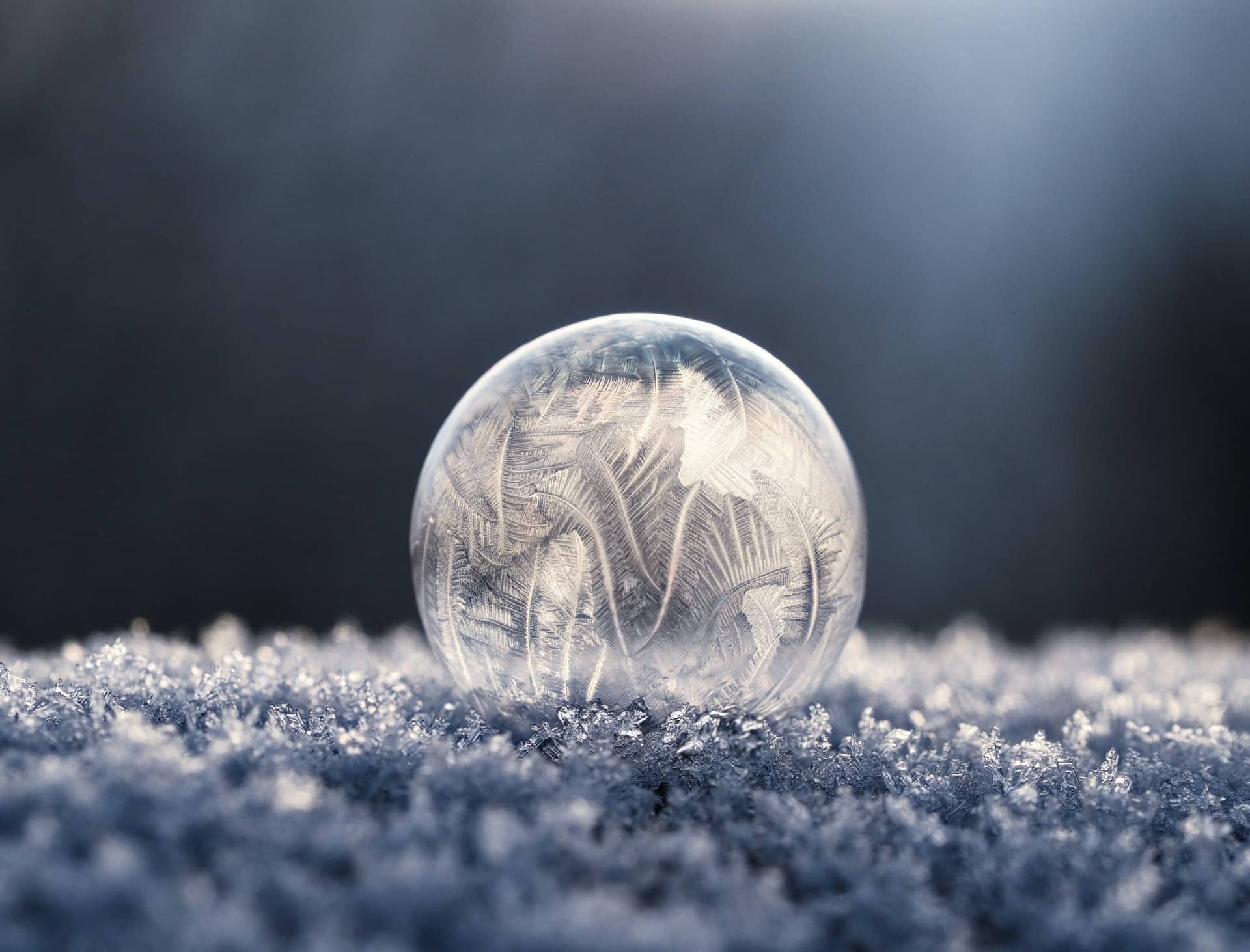 glass orb with ice designs covering it