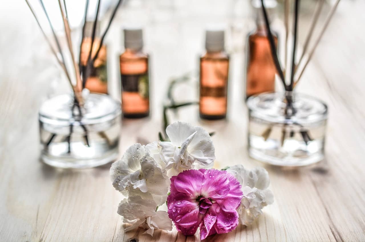 flowers on a table near aromatherapy sticks