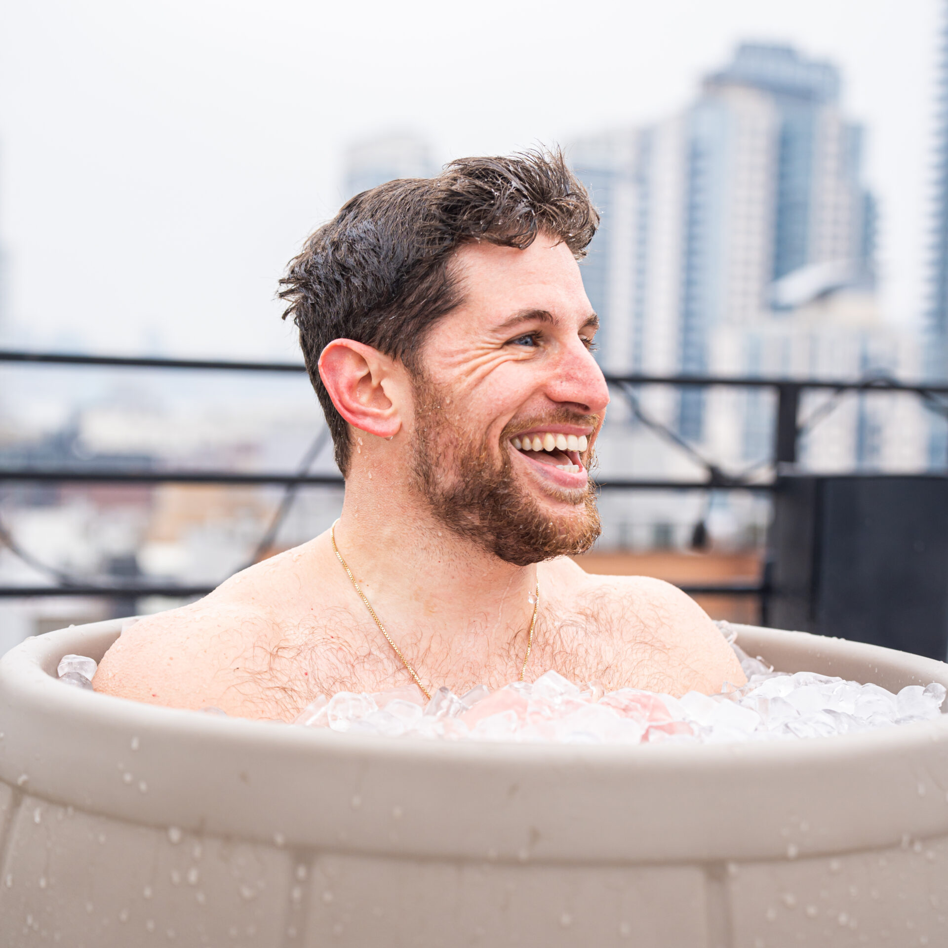 Man smiling during an ice bath in an Ice Barrel
