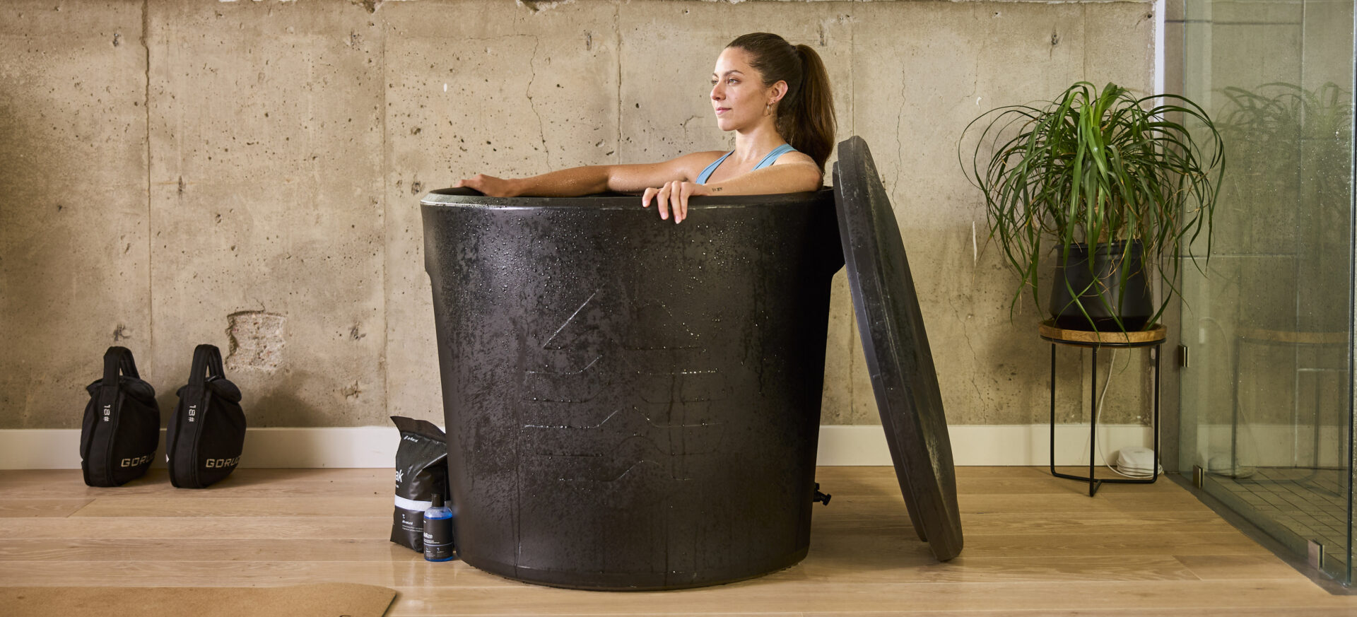 Woman relaxing while taking an ice bath in an Ice Barrel