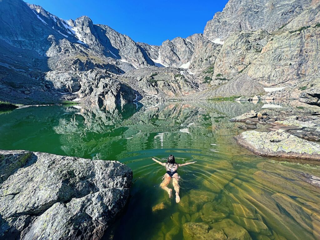 Women cold plunging at Sky Pond in Rocky Mountain National Park, Colorado