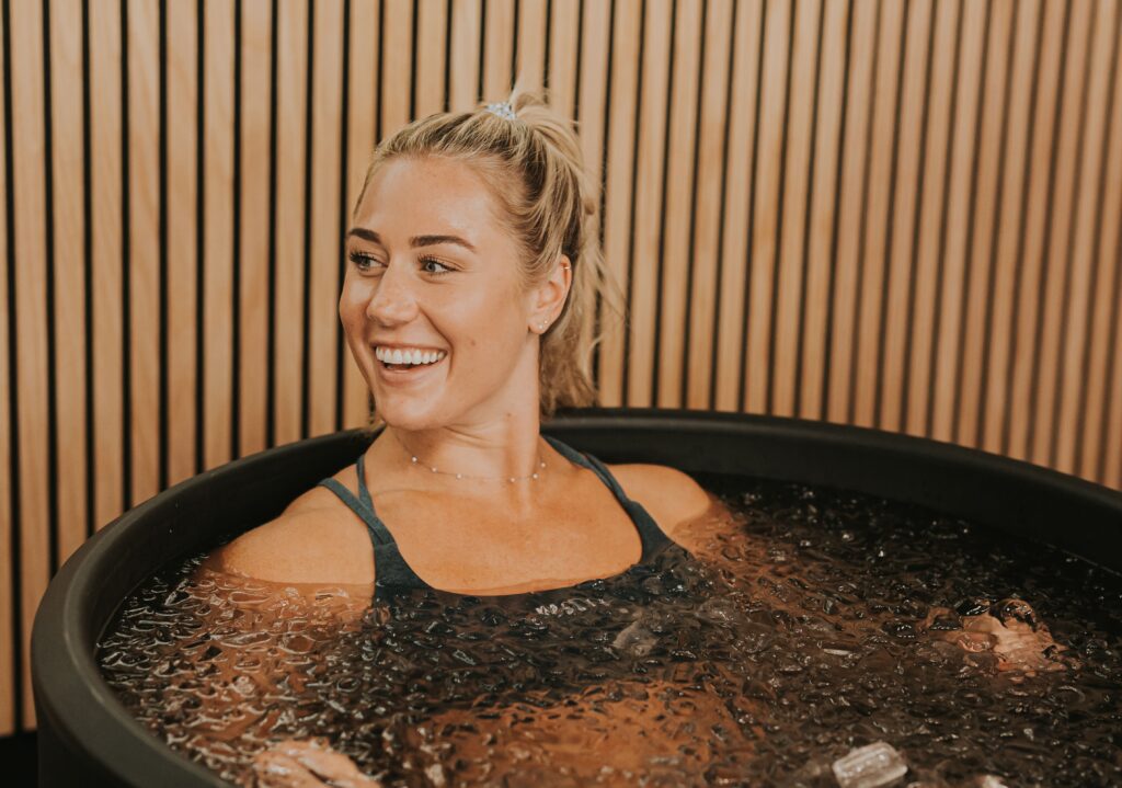 CrossFit Games Athlete Brooke Wells takes an ice bath in an Ice Barrel 300